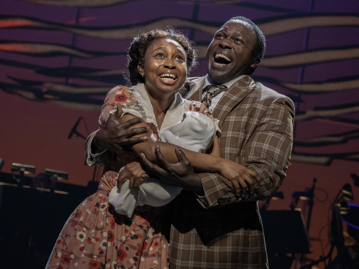 Sarah and Coalhouse are close together, emotional and holding their baby